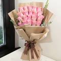 20 pink roses bouquet wrapped in kraft paper tied with a brown ribbon
