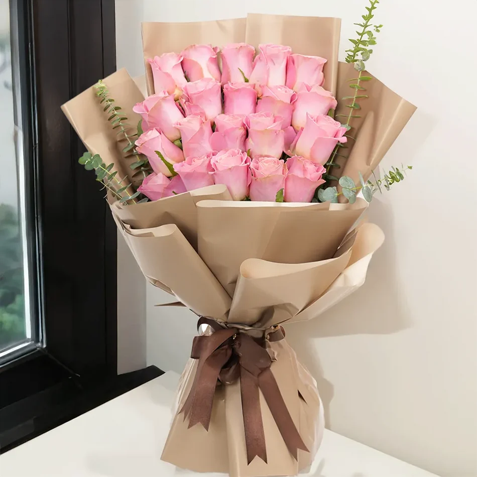 20 pink roses bouquet wrapped in kraft paper tied with a brown ribbon